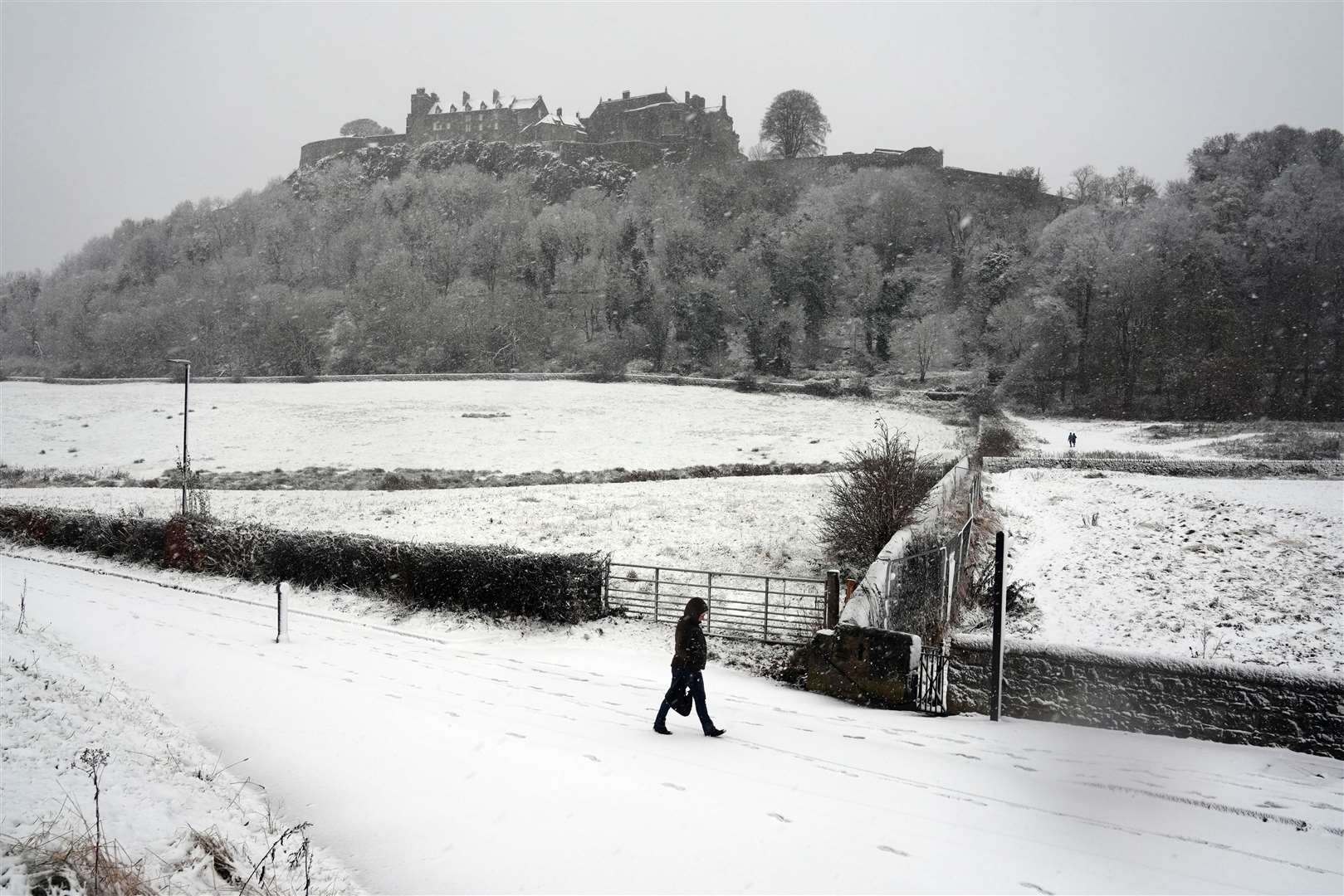 A person walks in the snow at Stirling Castle in Scotland (Andrew Milligan/PA)