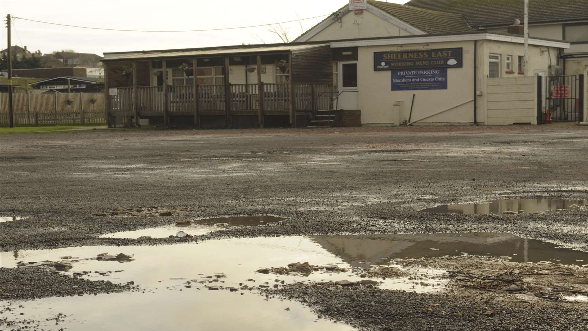 The pot-holed car park at Sheerness East Working Men's Club, Queenborough Road, Halfway