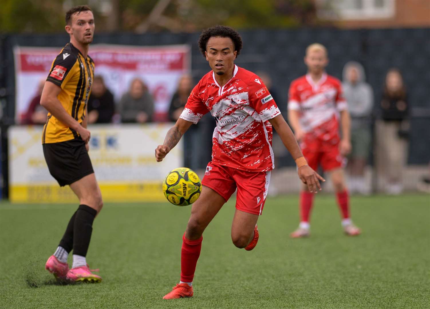 Midfielder TJ Jadama turning away from Folkestone forward Dan Smith for Ramsgate. Picture: Stuart Watson