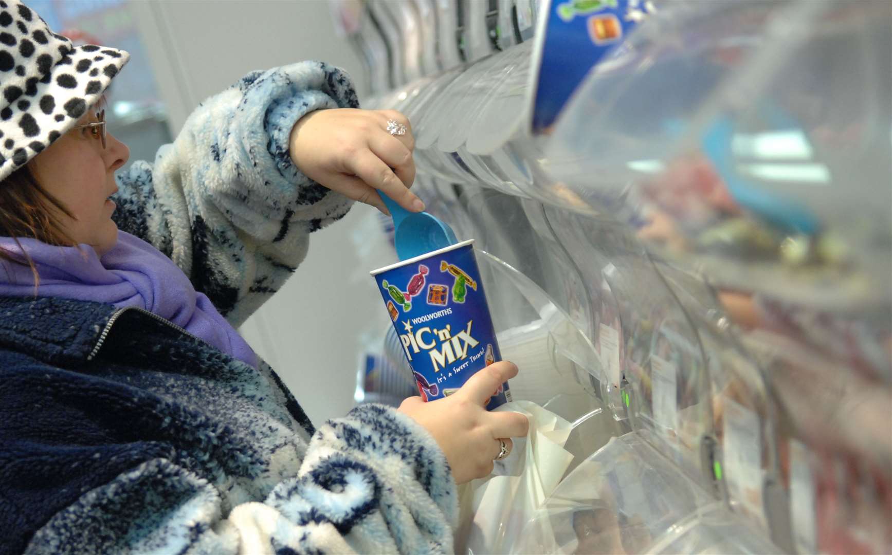 A shopper scoops some Woolworths Pic 'n' Mix sweets for the final time on the last day of trading for Woolworths