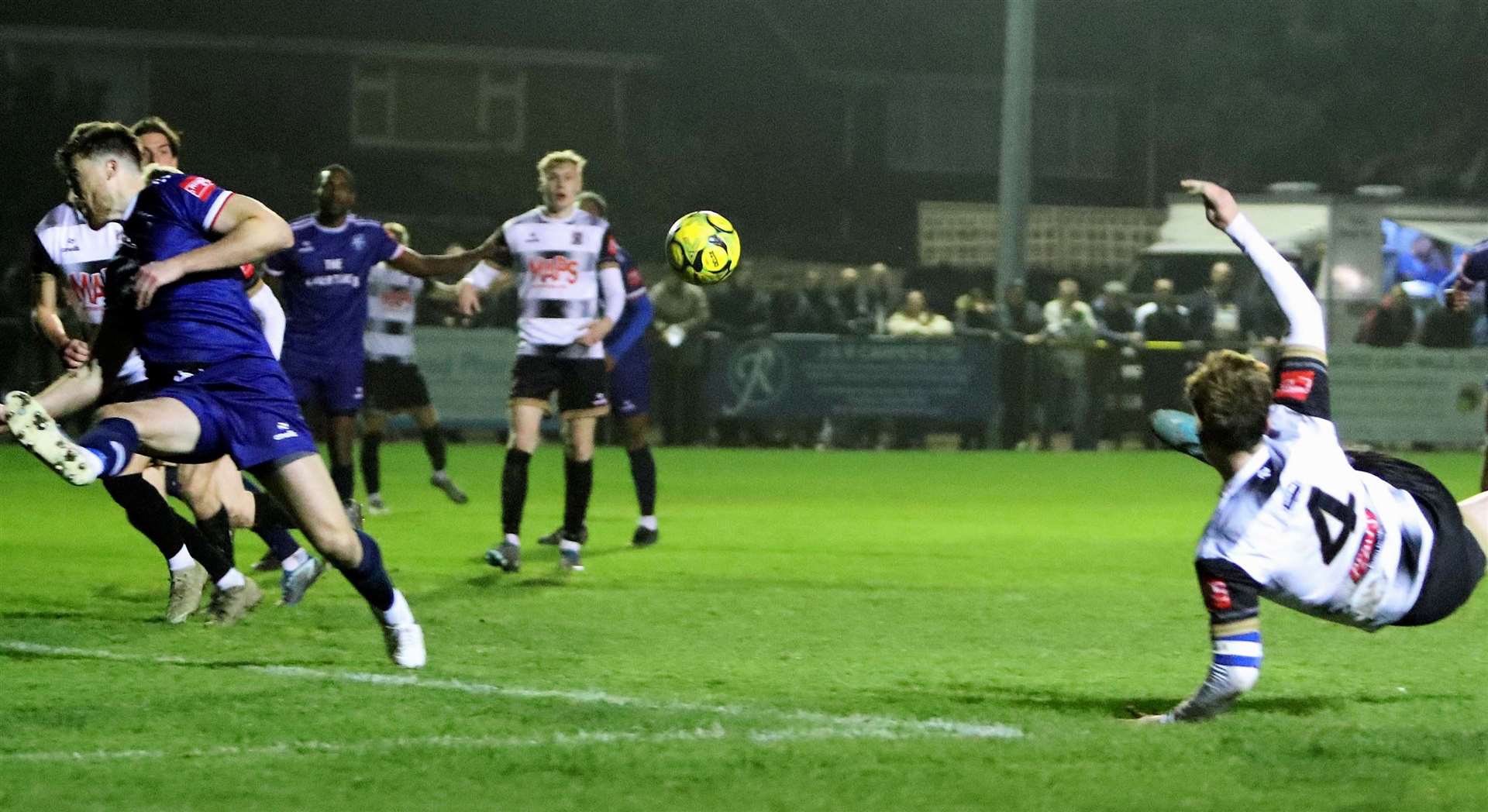 Deal defender Alfie Foster tries his luck with a spectacular injury-time strike as Margate's Lewis Knight puts his body on the line. Picture: Paul Willmott