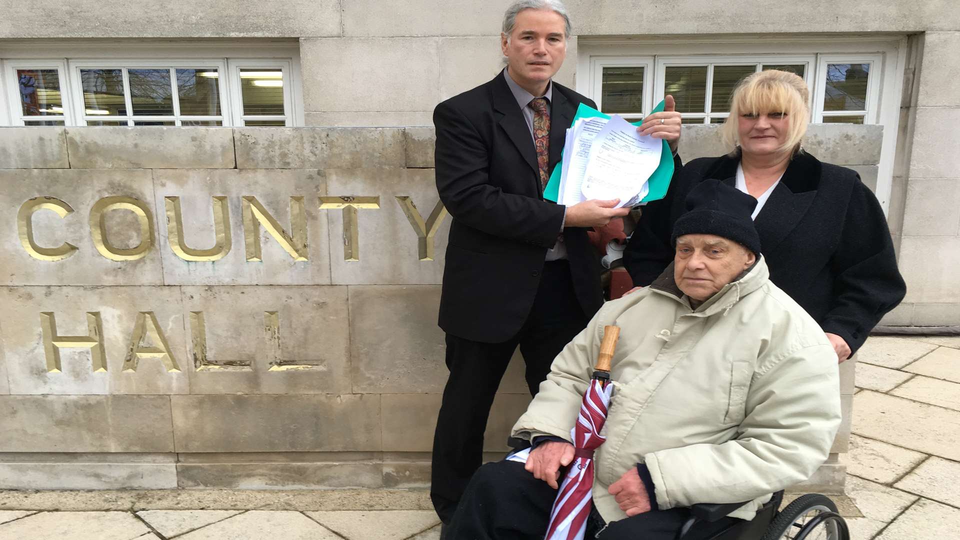 Cllr Brian Clark holds the petition papers, with Anna Ralph and her father, Dorothy Lucy Centre-user, John Hoggin