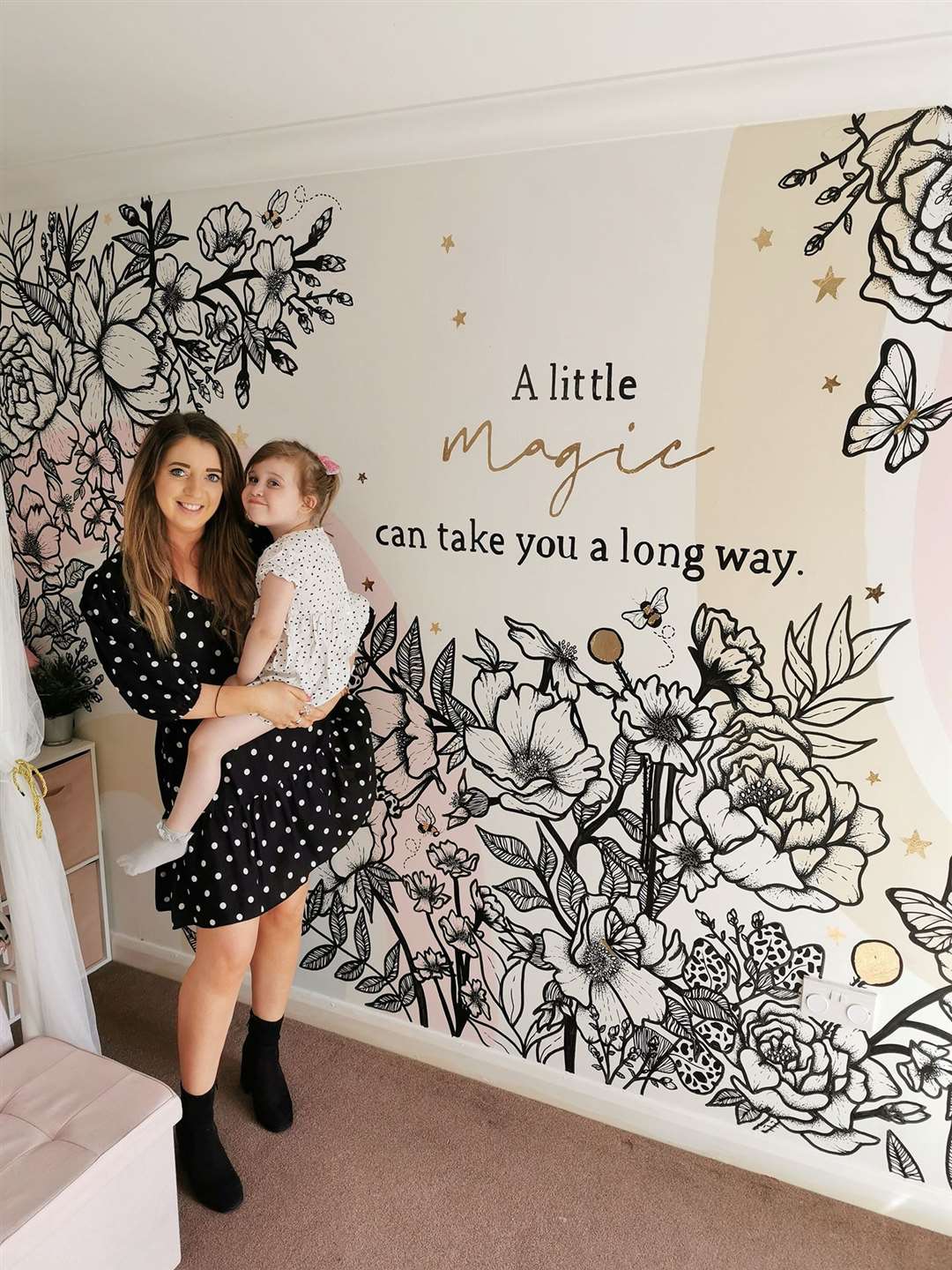 Becky Thomas and Lily Wheeler in front of the mural