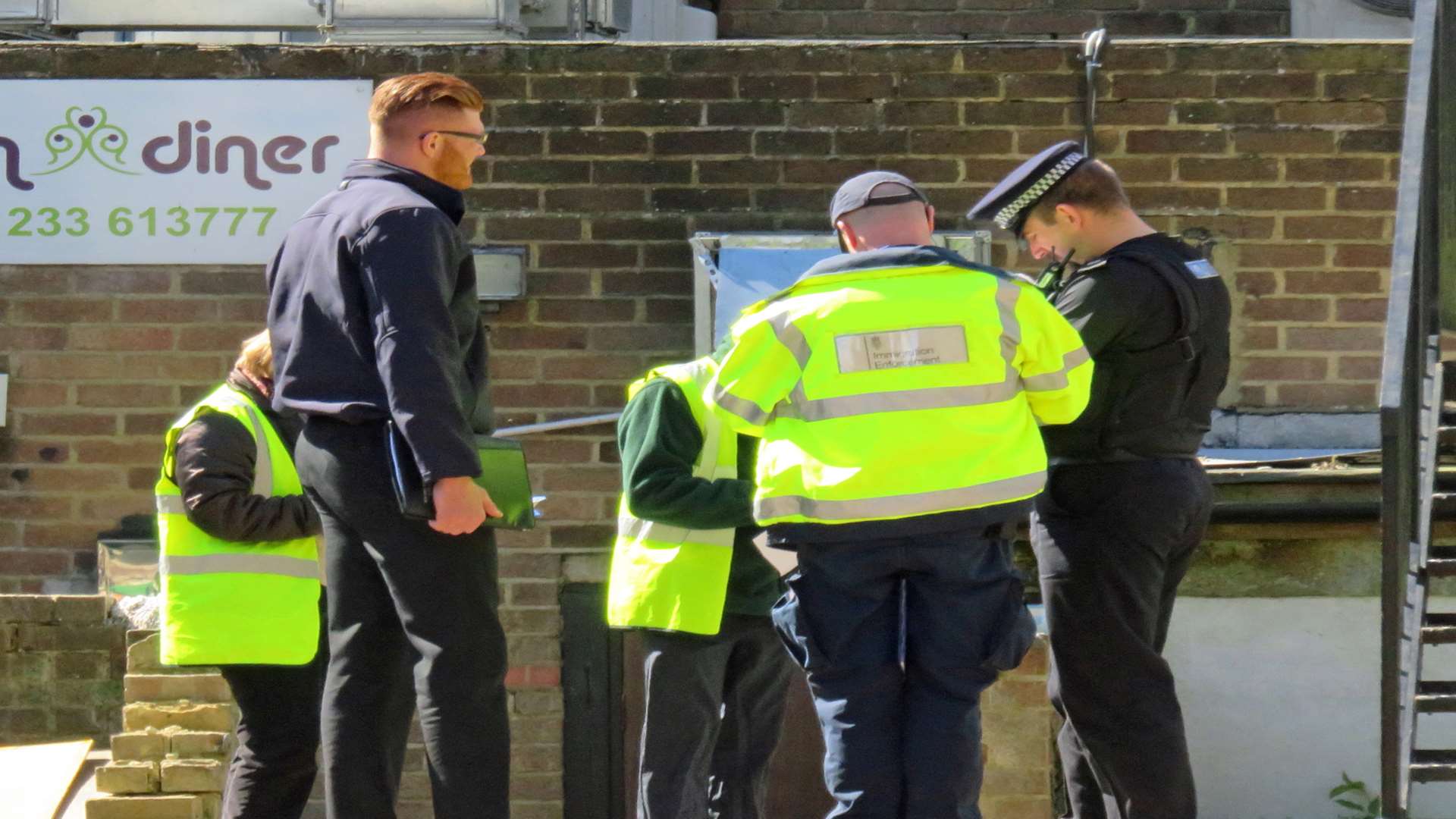 Immigration officers inspect kitchens in the Indian Diner in Ashford. Picture by Andy Clark