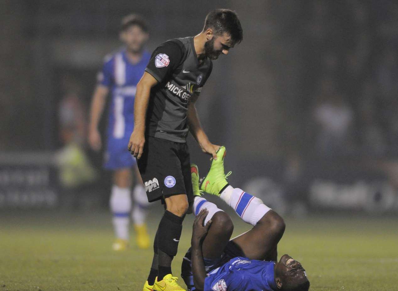 Former Gill Jack Payne checks on Jermaine McGlashan after fouling the winger Picture: Barry Goodwin