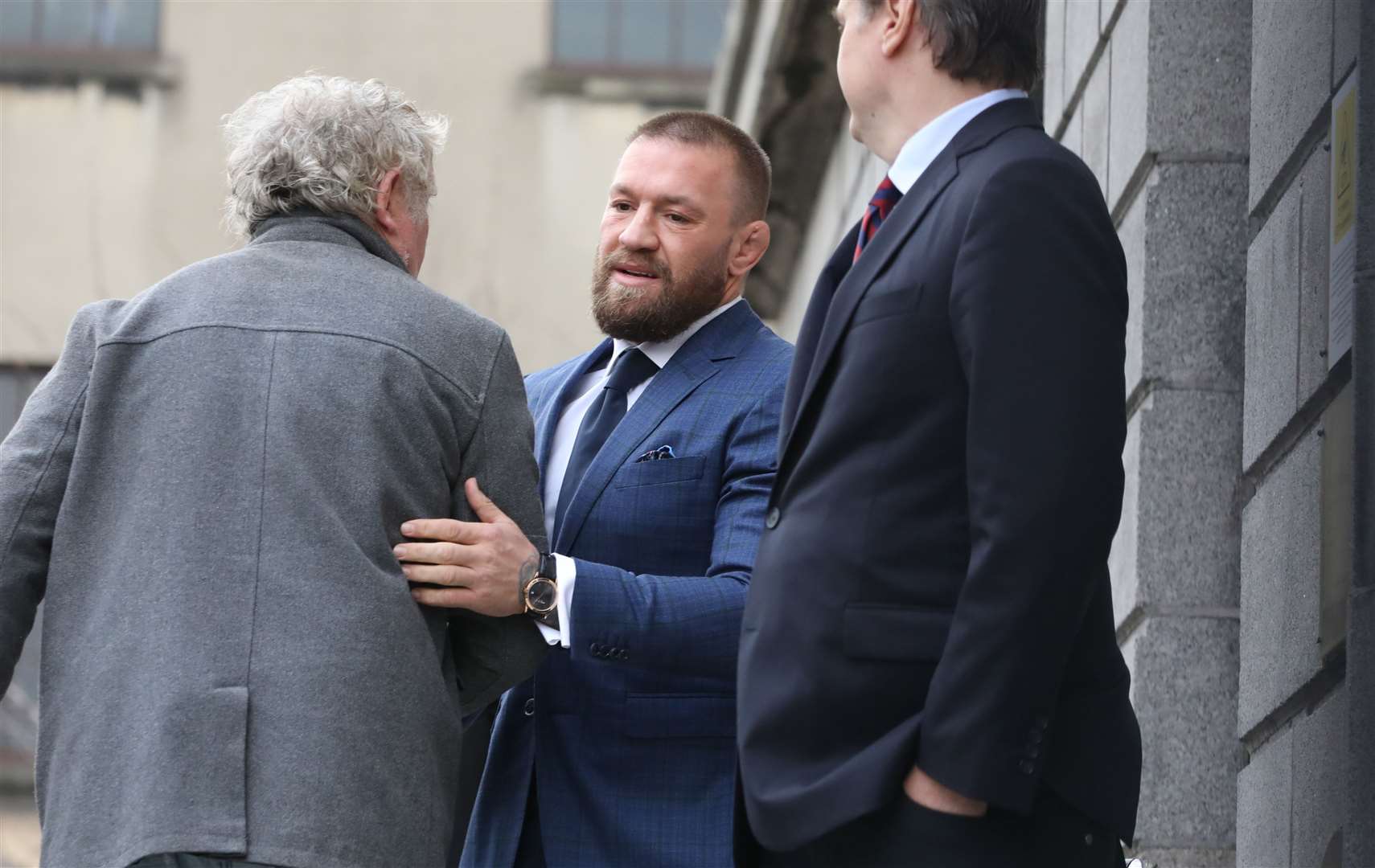 Mixed martial arts fighter Conor McGregor (centre) outside the High Court in Dublin, where he is appearing for a personal injury case against him (Gareth Chaney/PA)