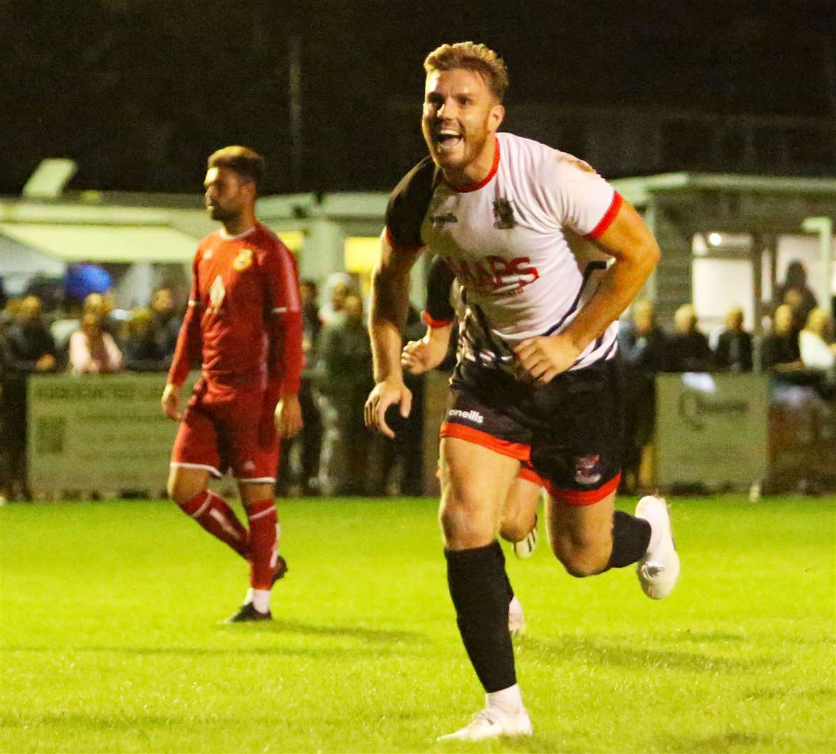 Former Herne Bay frontman Aaron Millbank, now of Deal, celebrates after scoring his penalty against former club Whitstable. Picture: Paul Willmott