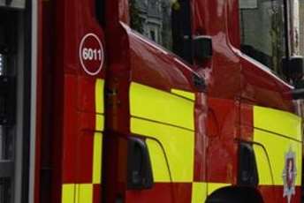 Fire fighters helped release a man from a car that had become trapped under the trailer of a lorry.