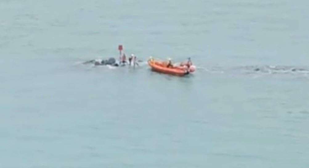 The teenagers were helped off the disappearing rocks two at a time. Picture: FolkestoneFollow on Instagram (14781923)