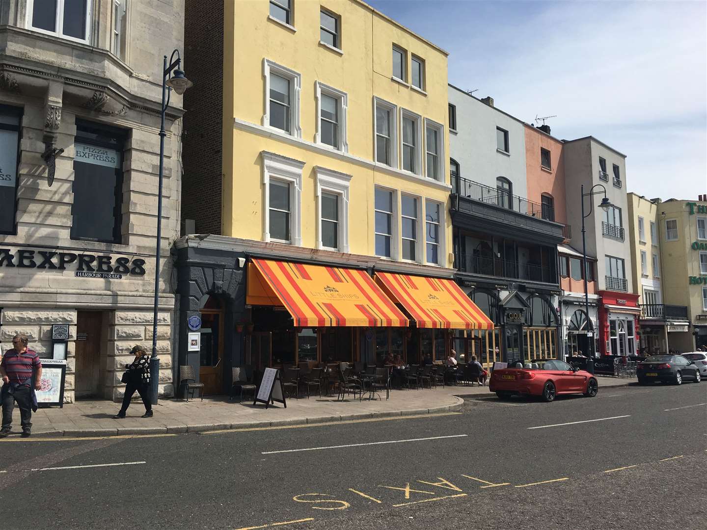 Under the giant awning out front, customers can drink their coffee or sip a mimosa or Bloody Mary and watch the world go by