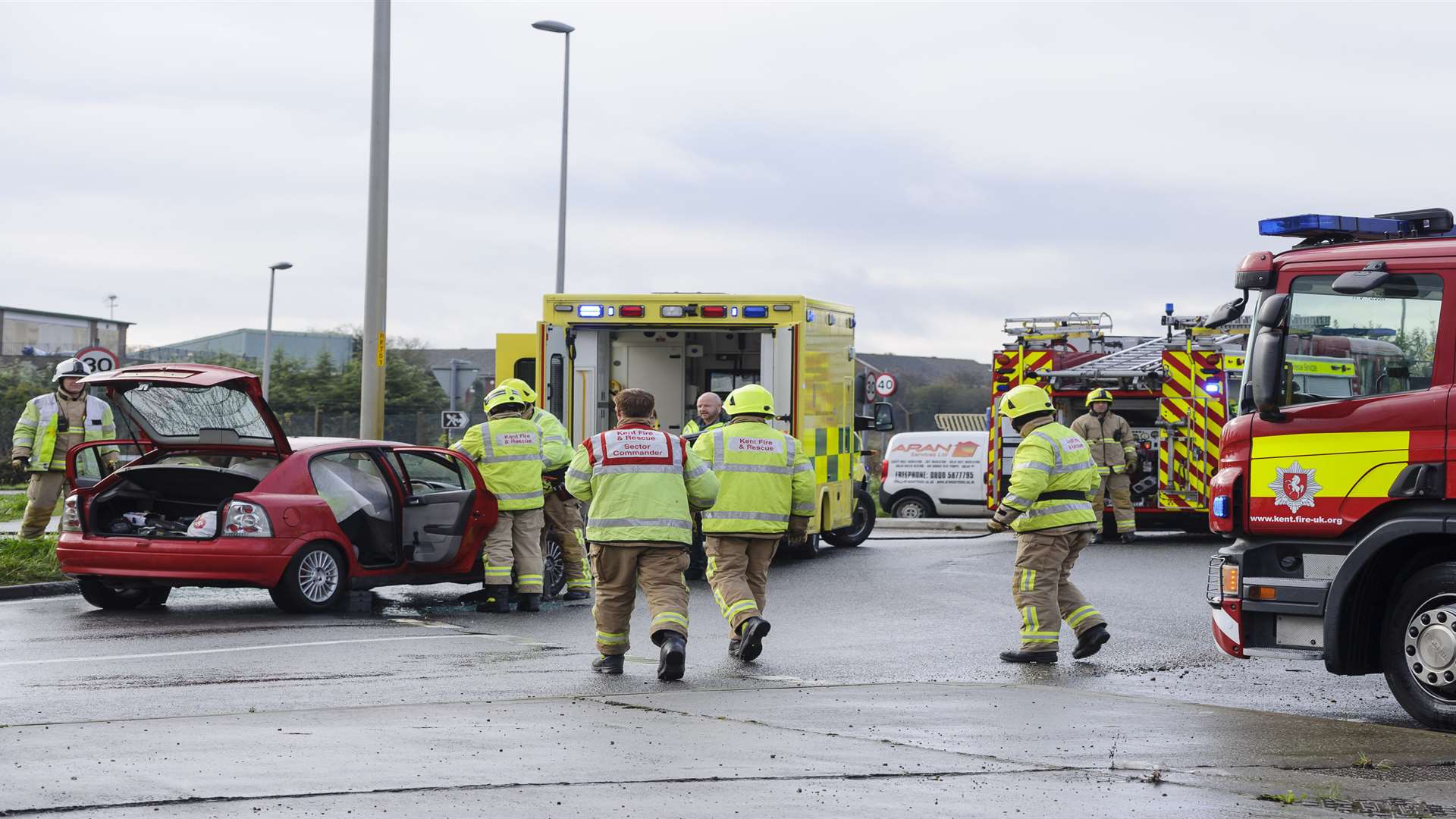 Firefighters preparing to remove roof. Emergency services at the scene of an incident on the A228. at the roundabout junction of Peninsula Way, Dux Court Road and Bell Lane.