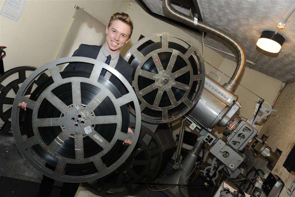 Rubin Powell shows the size of 35mm rolls of film