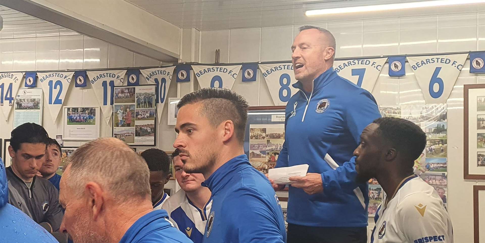 Bearsted club chairman Jamie Houston gives a speech to recognise long-serving manager Kevin Stevens in their Honey Lane clubhouse as rain buckets down outside