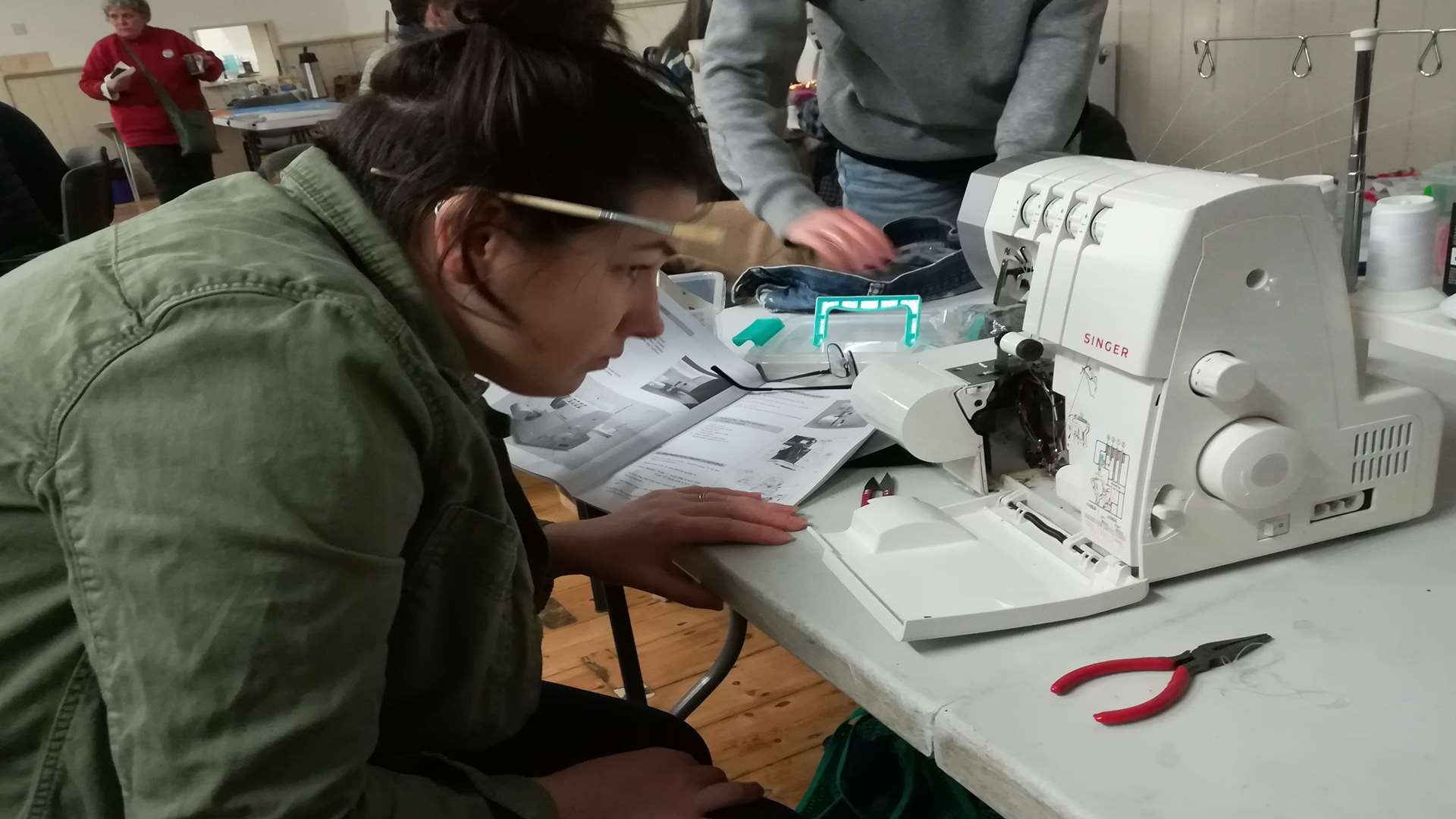 Amy Howie works on an overlocker machine at the repair workshop. Picture: Transition Dover