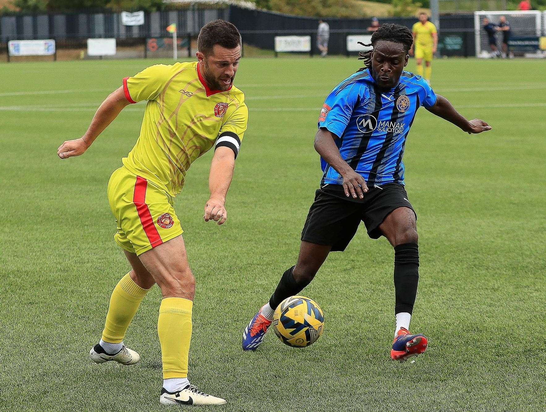 Whitstable captain Mike West twists and turns around Sevenoaks player Salim Futa. Picture: Les Biggs