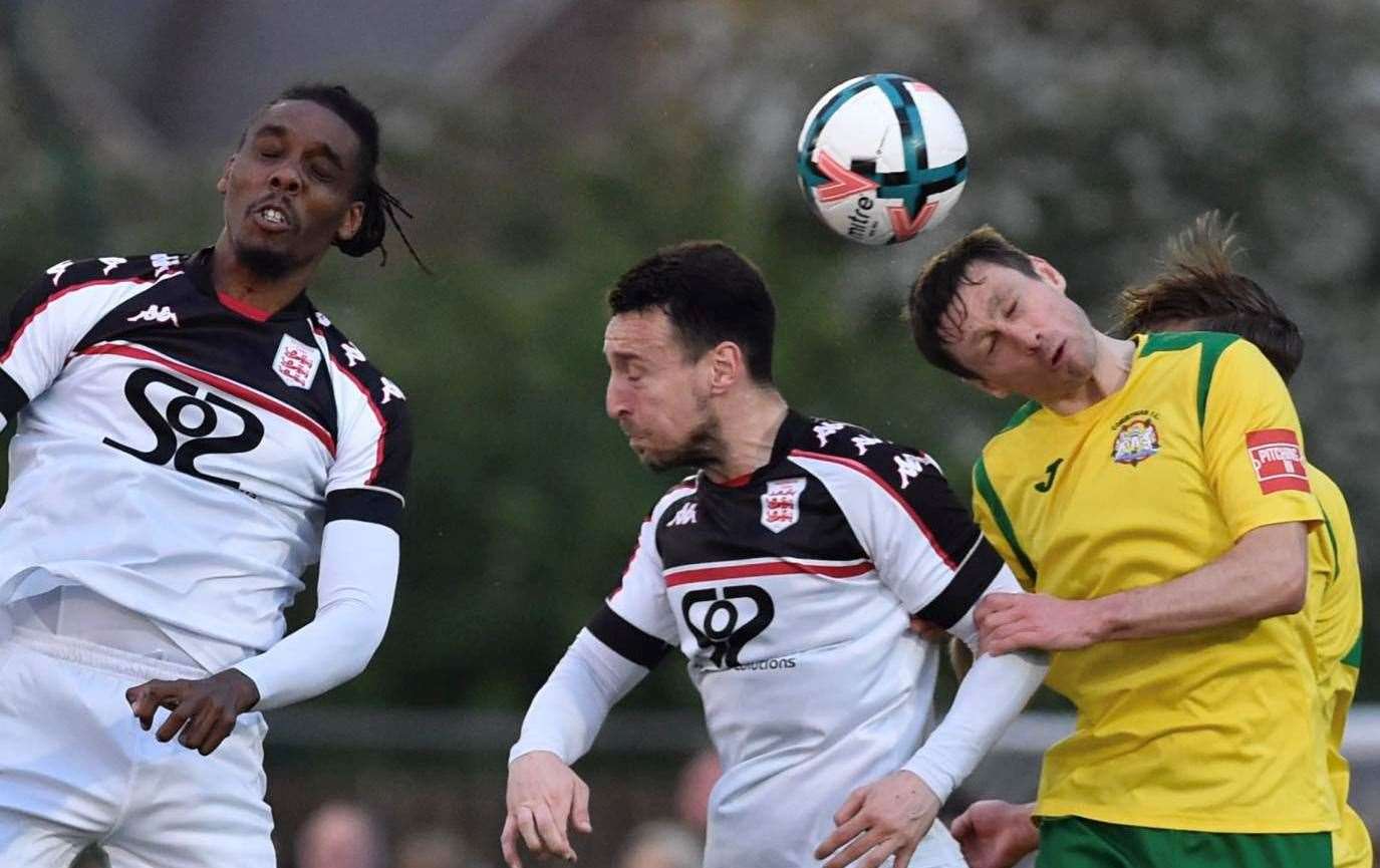 Faversham pair Ben Gorham and Daniel Thompson are beaten to the ball by a Corinthian defender as it finished 2-2 after 90 minutes. Picture: Ian Scammell