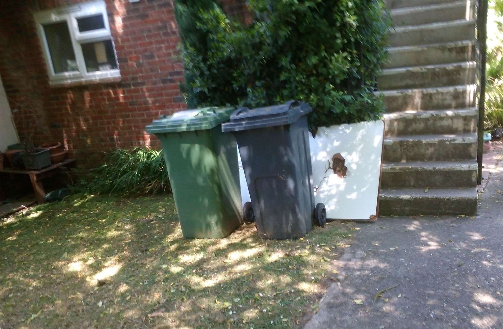 The battered bathroom door put out with the rubbish