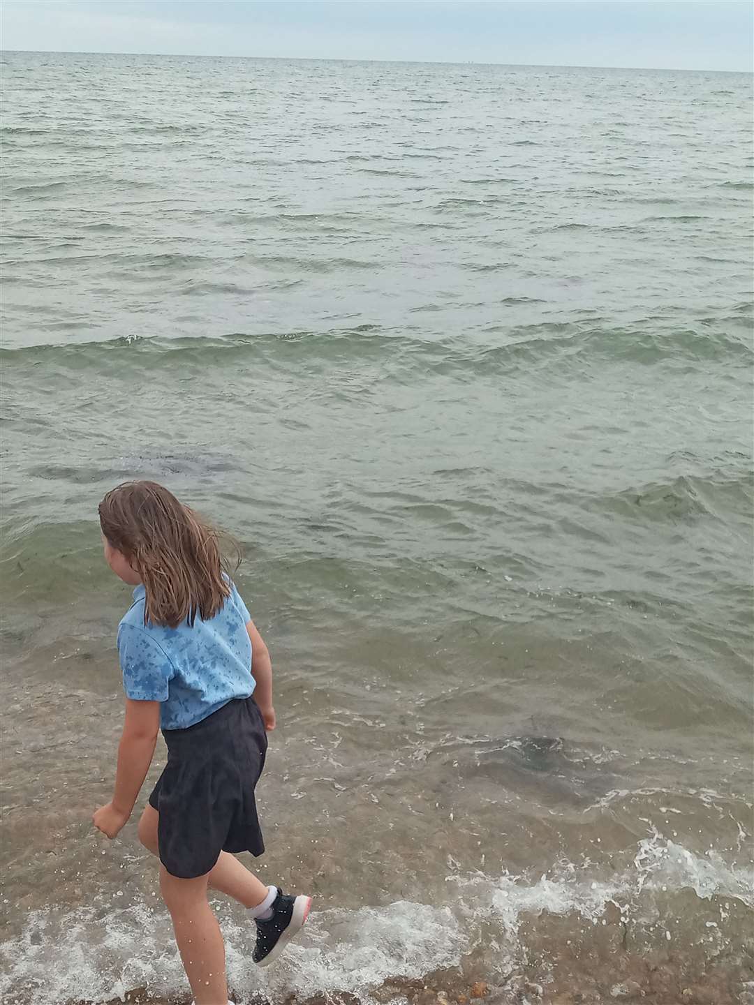 Sophia Baker’s daughter Josie had a paddle in her school uniform on her last day at school. Picture: Sophia Baker