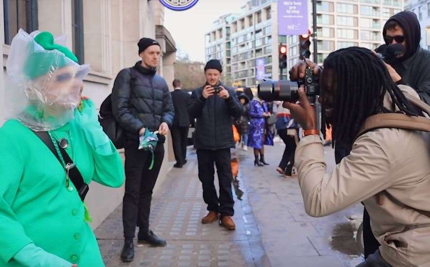 Elizabeth being snapped after being turned away from the Burberry catwalk show