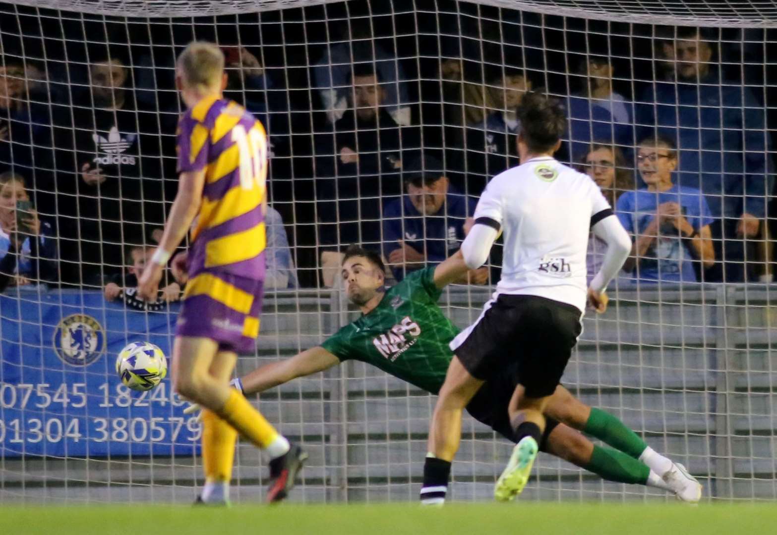 A George Nikaj penalty just evades the reach of Deal keeper Henry Newcombe on his way to a hat-trick. Picture: Paul Willmott