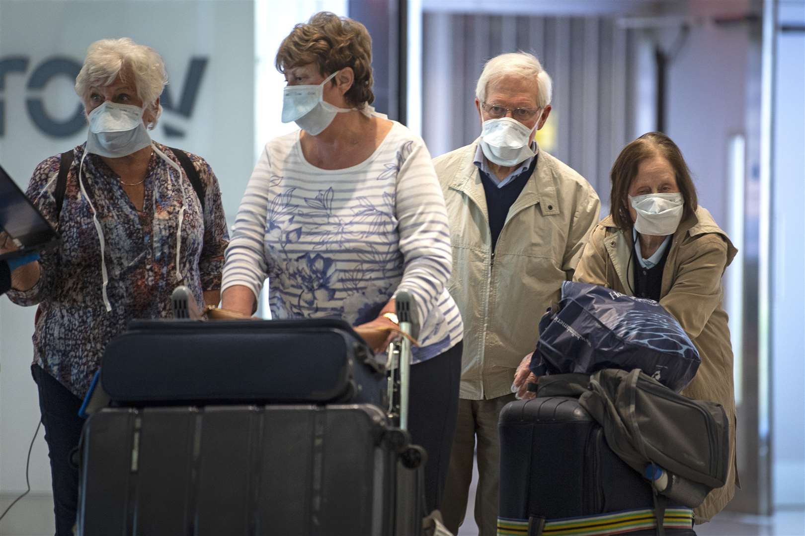 The cruise ship passengers arrive back in the UK at Heathrow Airport (Victoria Jones/PA)