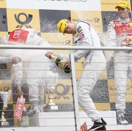 Race winner Paul Di Resta celebrates on the podium with Timo Scheider and Martin Tomczyk