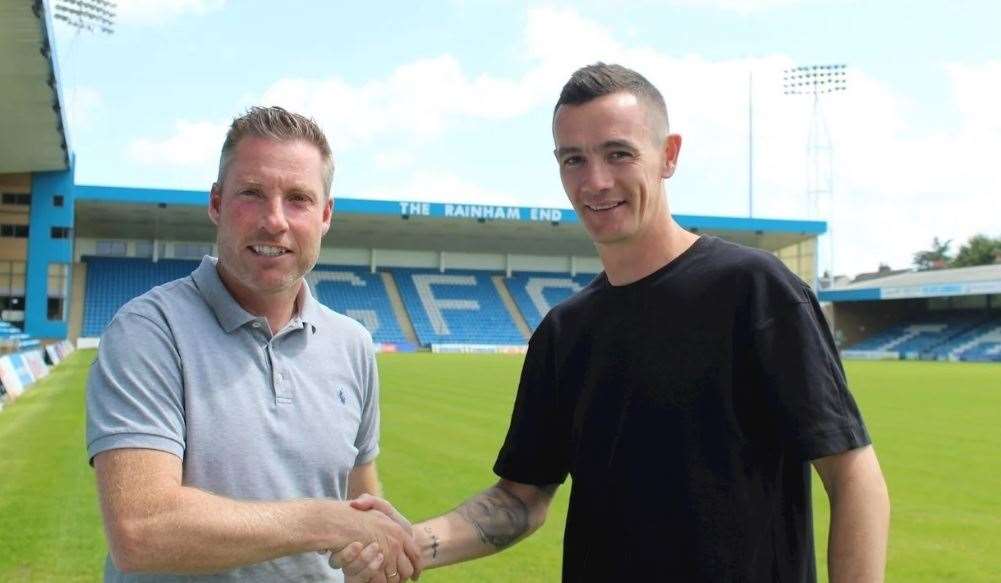 Gills boss Neil Harris with midfielder Shaun Williams. Picture: GFC