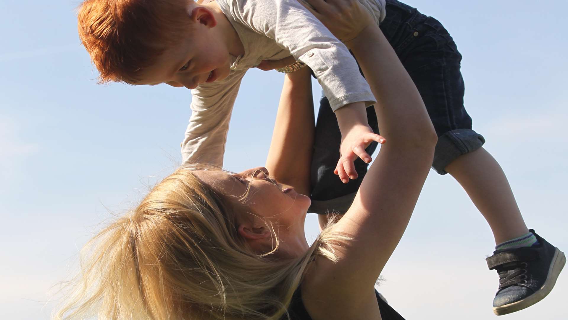 Charlotte Erskine-Howden, 22, holds up her son to the sky, James Rushworth, four, on top of Jackson Field near Fort Pitt Grammar School in Rochester. Picture: John Westhrop