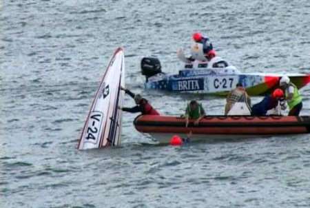 The rescue crew pull the two men involved in the crash from the water. Picture: MIKE PETT