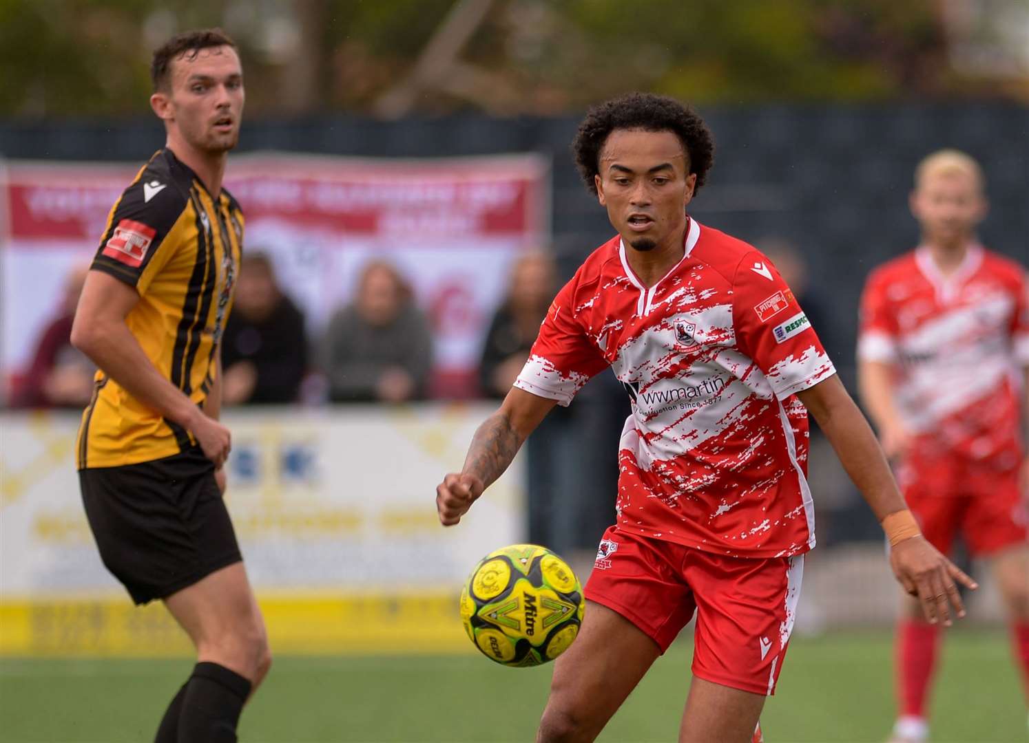 Ramsgate’s TJ Jadama turning away from Folkestone forward Dan Smith. Picture: Stuart Watson