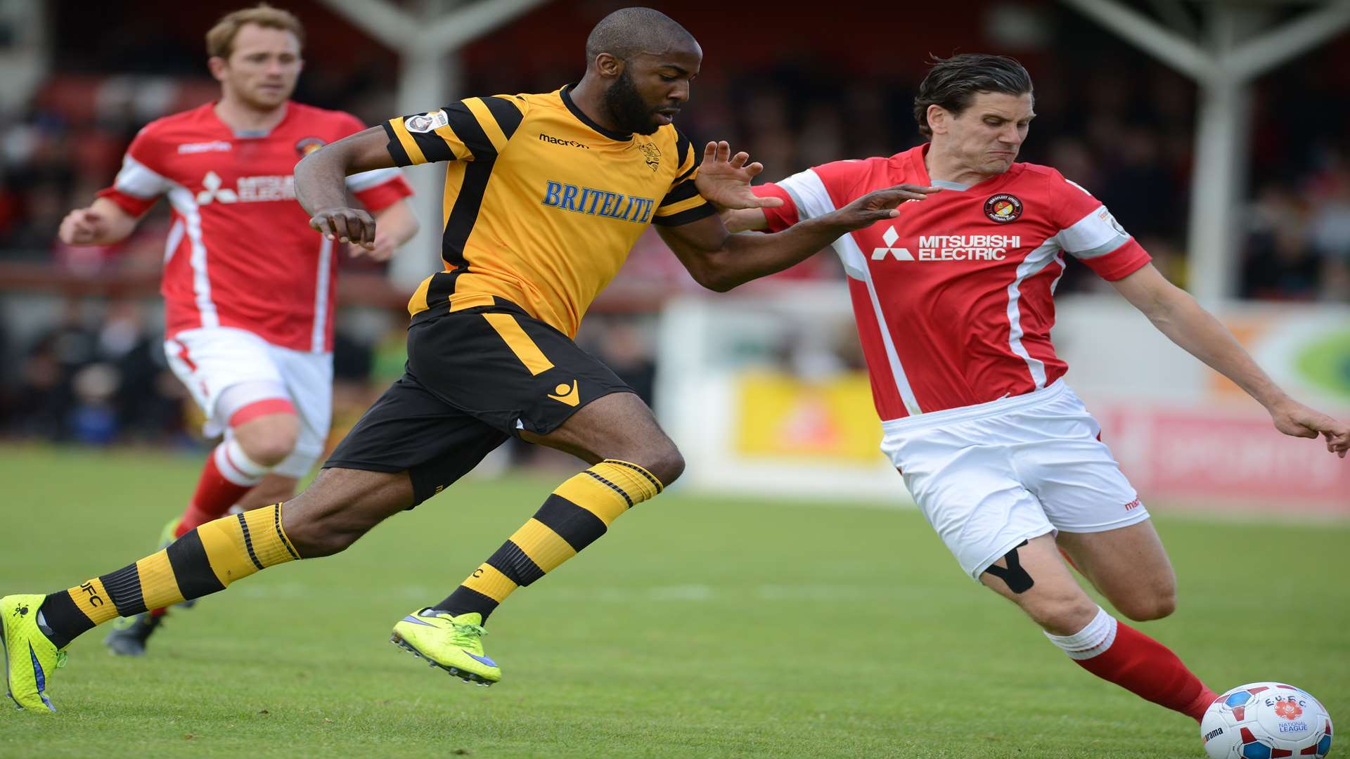 Tom Bonner holds off Maidstone goalscorer Dumebi Dumaka Picture: Gary Browne