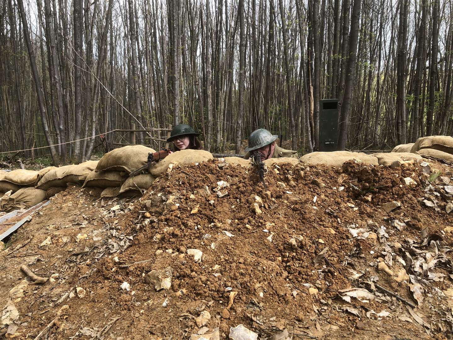 Craig Appleton, right, demonstrates how soldiers would line up their weapons in the sandbag wall to shoot the enemy