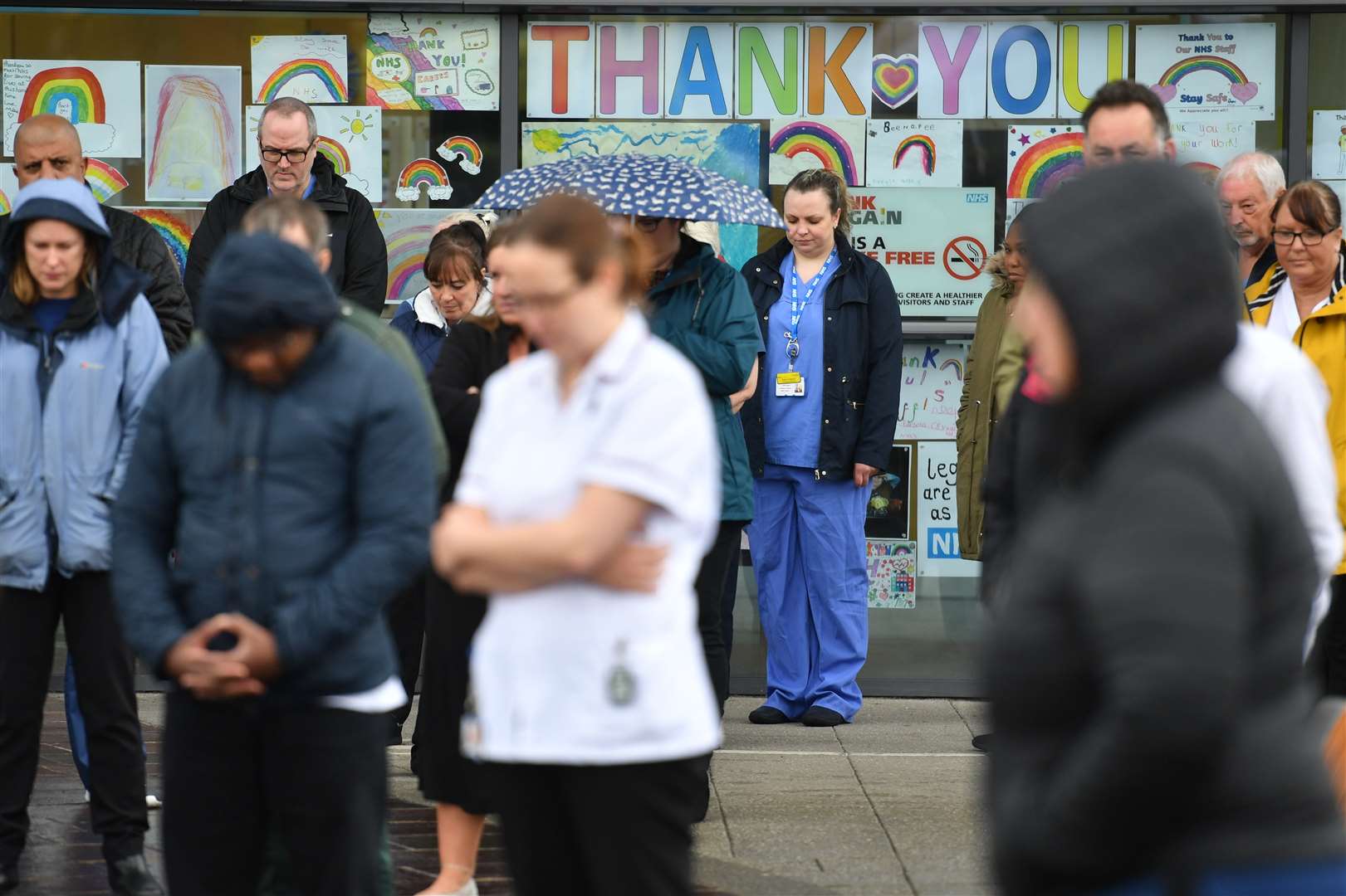 Staff stand outside the Royal Derby Hospital during the minute’s silence (Jacob King/PA)