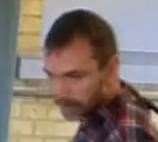 Police have released an image of a man they would like to speak to after a woman was bitten by a dog on a train