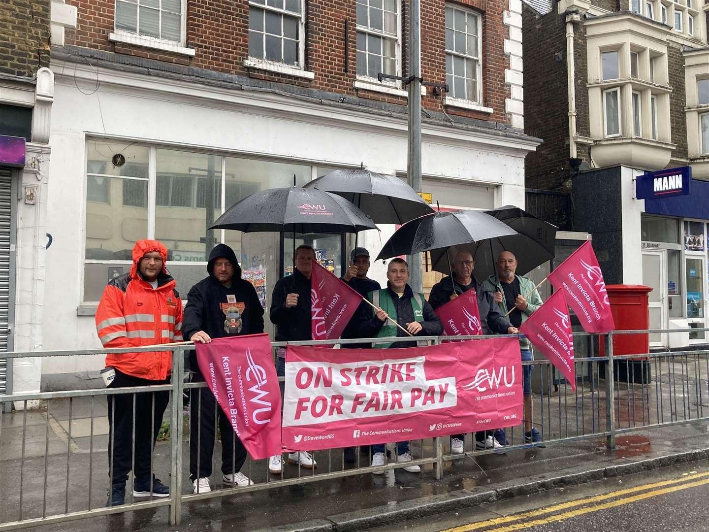 Communication Workers Union pickets striking in the rain outside the Royal Mail's depot in Sheerness Broadway