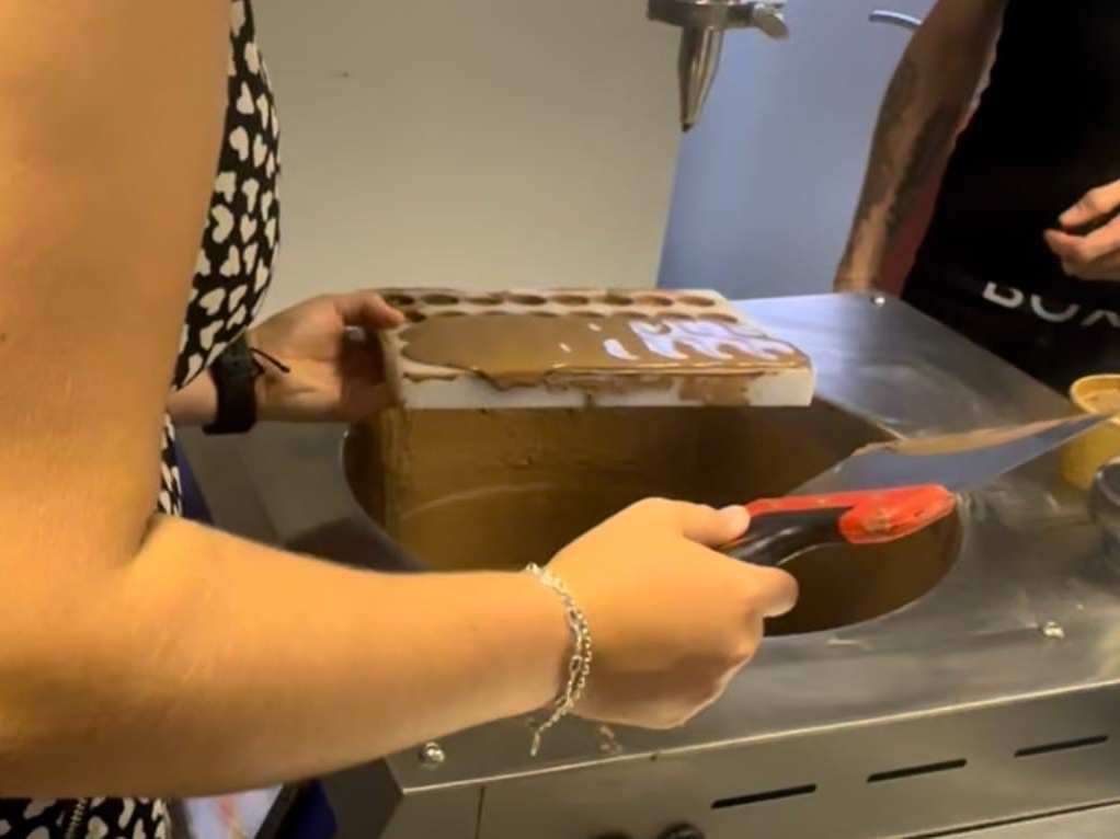 Reporter Megan Carr making mini caramel-filled milk chocolate bon bons. Picture: Megan Carr