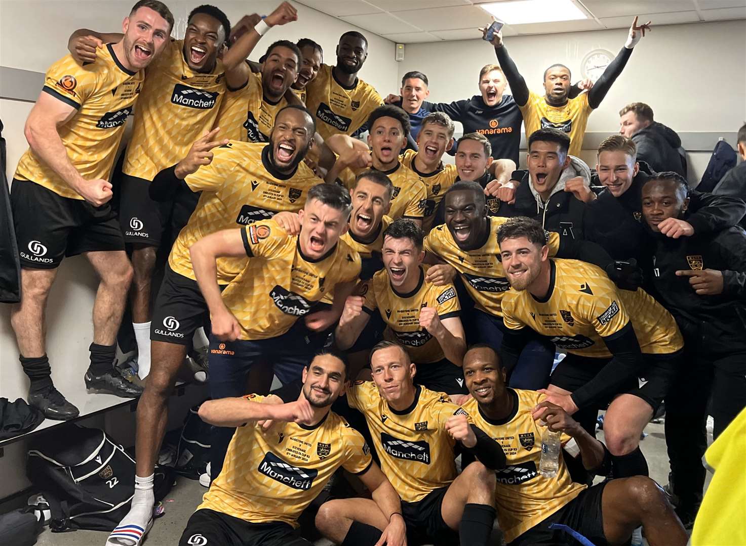 Maidstone United players celebrate in the dressing room after beating Stevenage. Picture: Steve Terrell