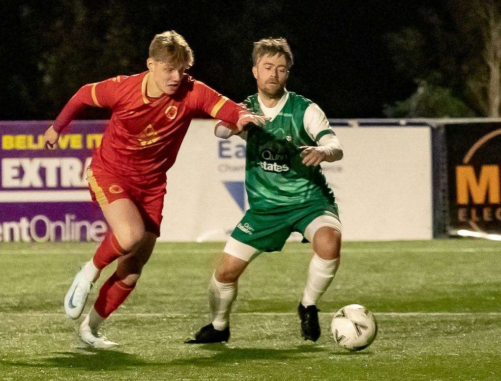 Whitstable's Fin Dent battles with Canterbury City defender Liam Hark. Picture: Les Biggs