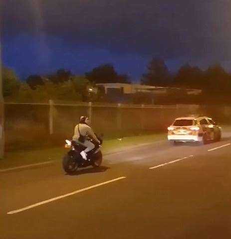 Biker bhind police patrol car (14845352)