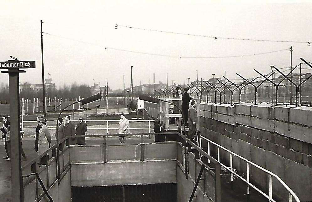 Civilians trying to talk over the Berlin Wall to friends or relatives in the East