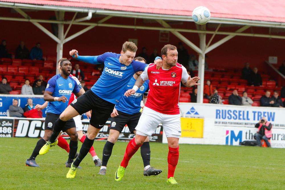 Danny Kedwell challenged by Ryan Bird Picture: Andy Jones