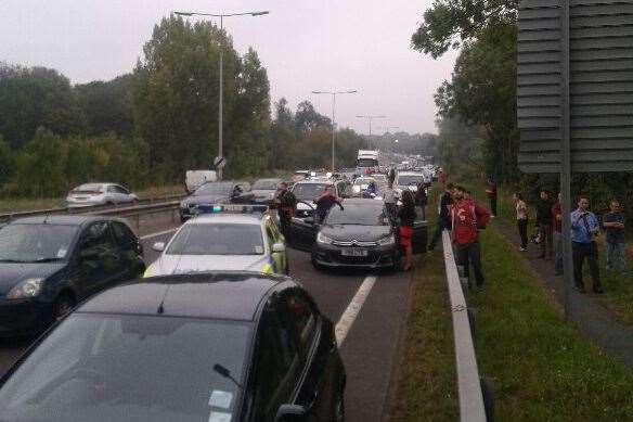 Traffic is gridlocked and people are getting out of their cars