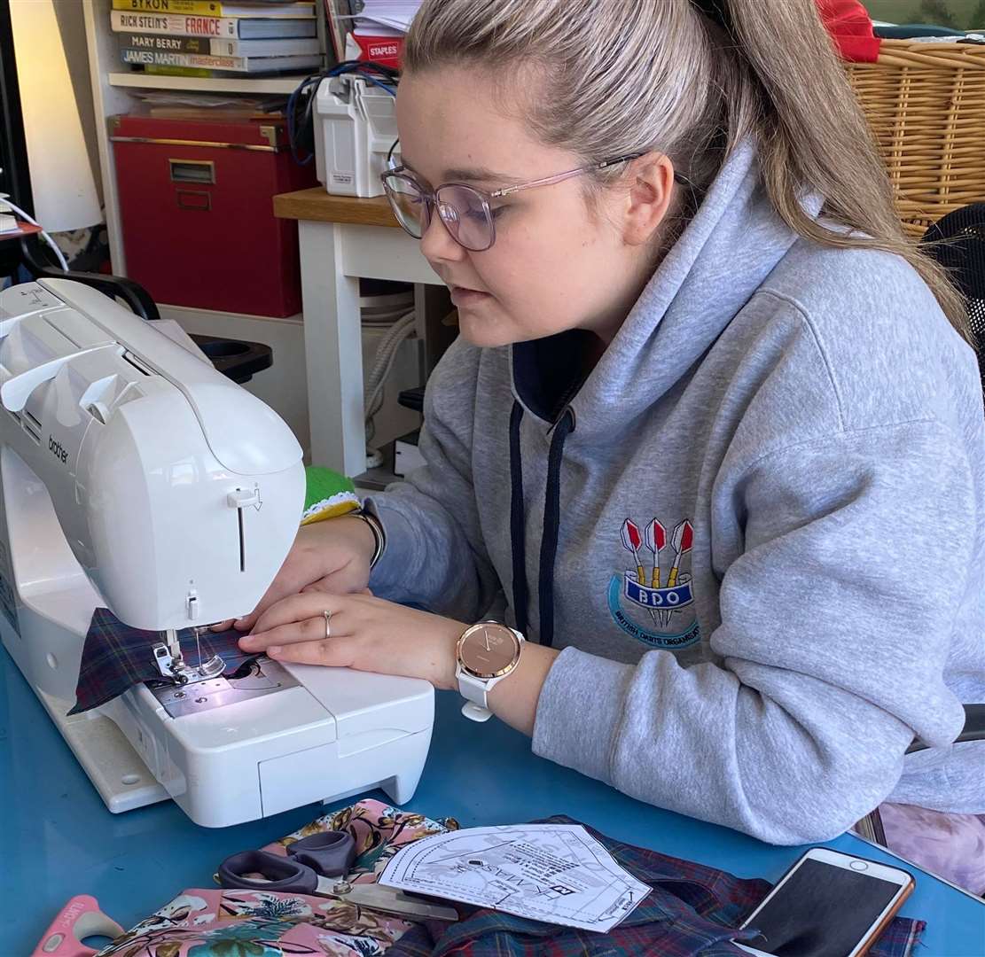 A daughter of a staff member makes a surgical mask. Picture: Britt Grutzmacher