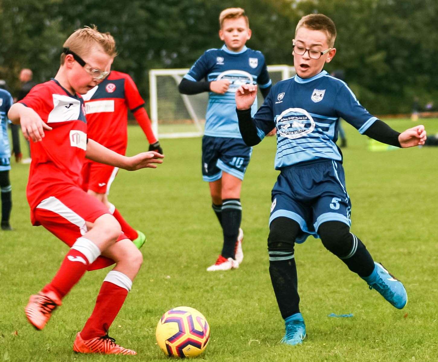 Hempstead Valley Youth under-11s (red) are closed down by Rochester City Blue under-11s Picture: Phil Lee FM19227349