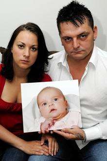 Mark-Antony Jones and Lucy-Rae Tamulevicius with a picture of their daughter Xara-Mae