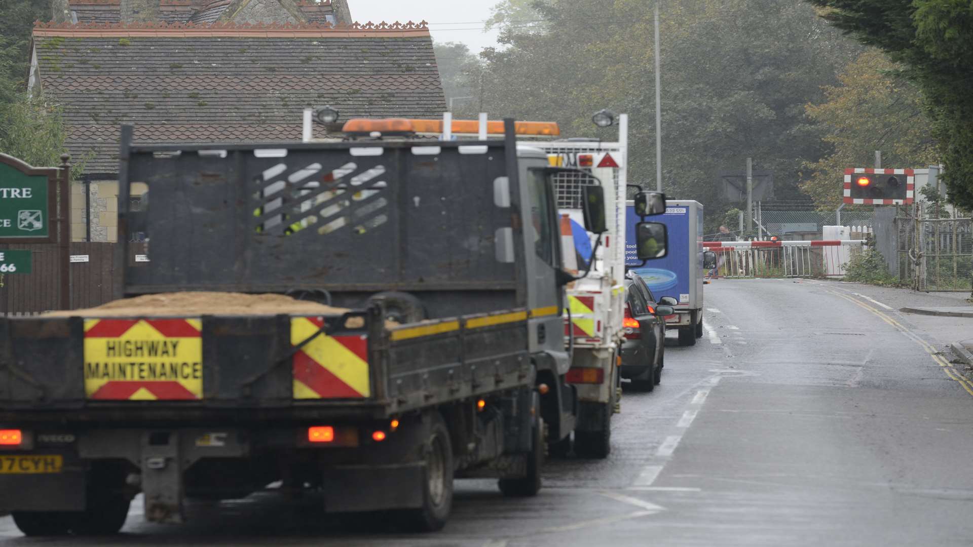 Traffic builds at the level crossing in Station Road