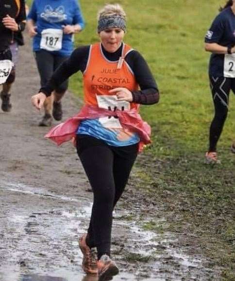 Julie Pitchford running an event in her club colours