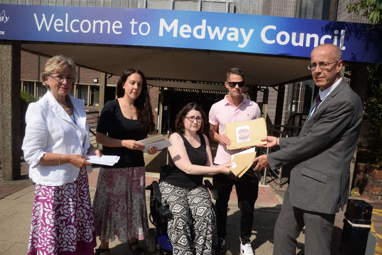 Cllr Kristine Carr, Catriona Jamison, Kate Belmonte and Cllr Martin Potter hand over petitions to Dave Harris, head of planning at Medway Council, over the proposed Pump Lane housing development at the council offices last August. Picture: Chris Davey