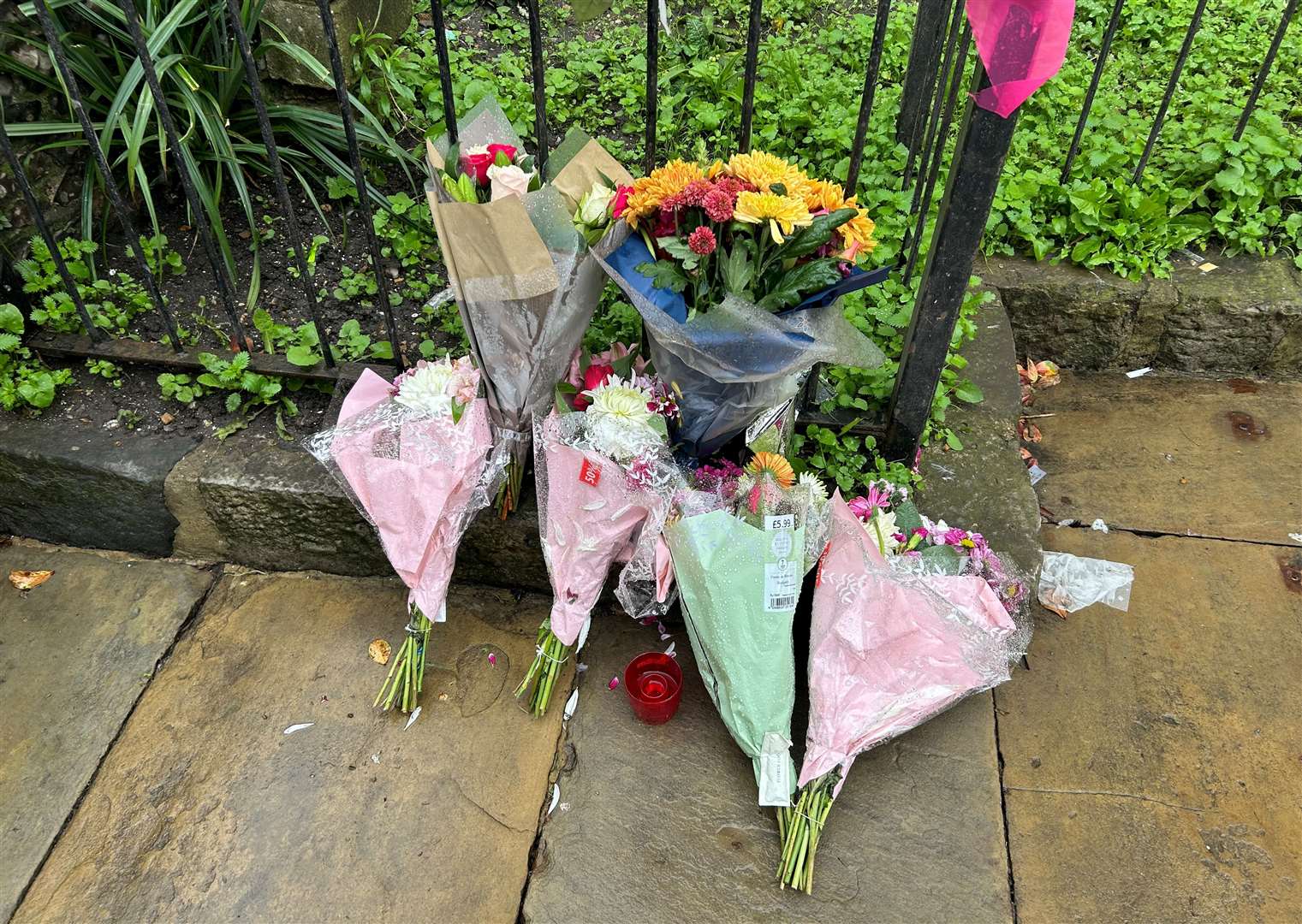 Flowers left at the scene in Canterbury high street where a 23-year-old man was stabbed to death