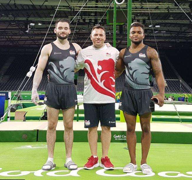 Pegasus gymnasts James Hall and Courtney Tulloch with coach Ionut Trandaburu